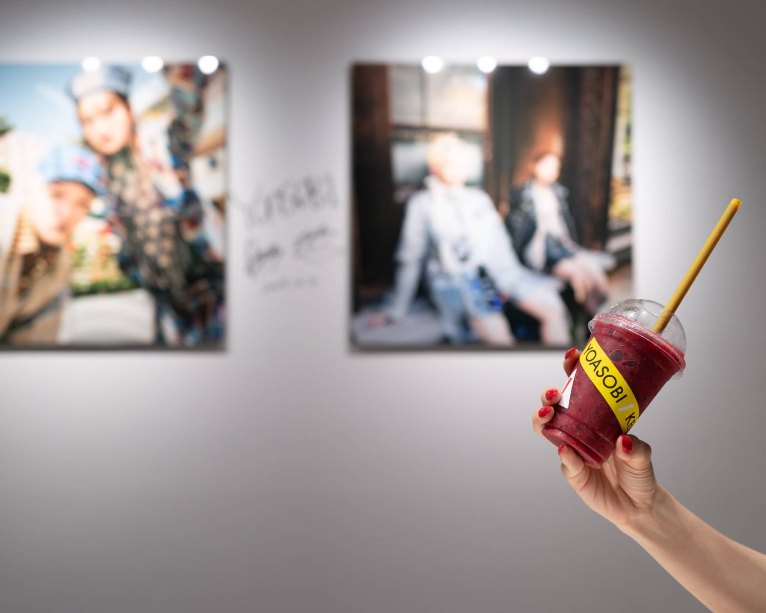 Exhibit. Holding up the collaboration beverage.
