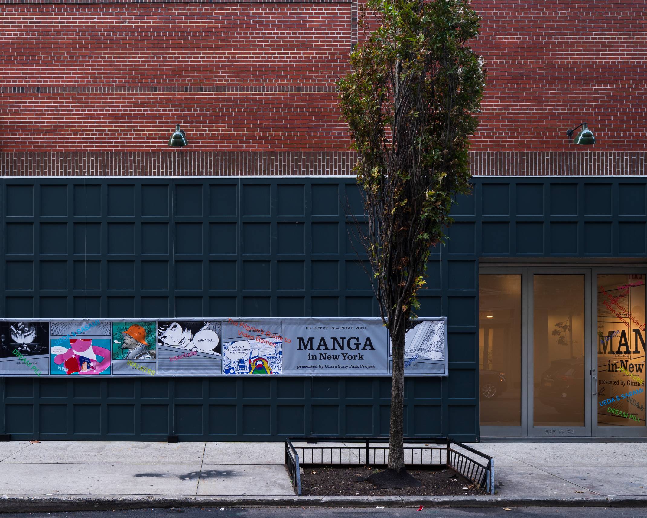 Exterior. The “MANGA in New York” sign hanging on a dark teal tiled wall.