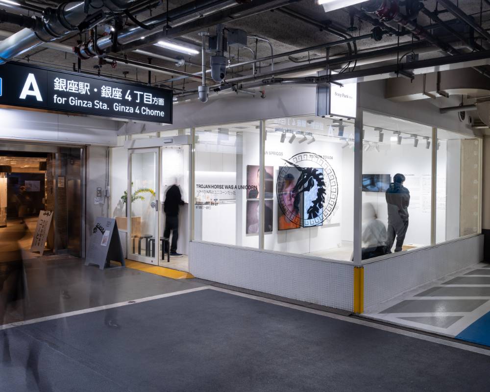 Exterior. Art pieces like portraits and drawings are displayed on the walls of the exhibition space.